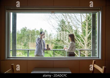 Man and Woman Laughing on the Terrace of Cafe Stock Photo
