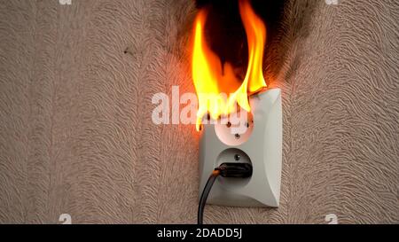 Fire caused by short circuit. The concept of a fire in the house Stock Photo