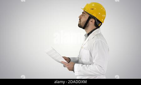 Contractor engineer walking with papers and checking arround on Stock Photo