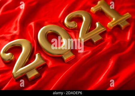 Golden numbers 2021 on a silk background. The concept of the coming new year Stock Photo