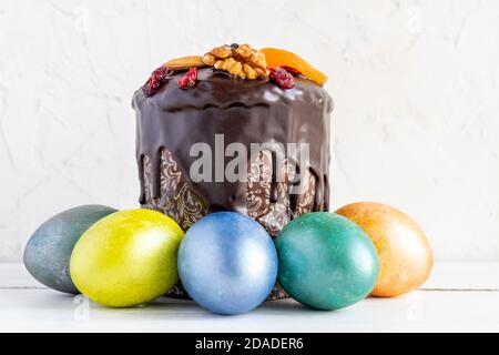 Easter cake and colored eggs on white background. Holiday food and easter concept Stock Photo