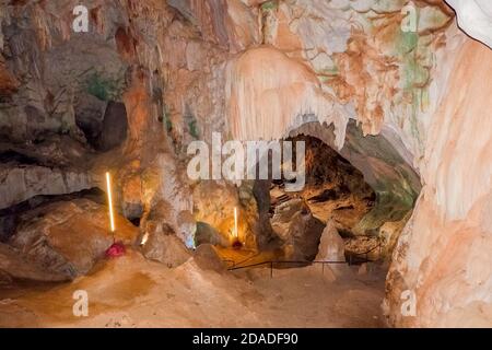 tourist cave .High arches of a huge stone cave with round holes at the ...