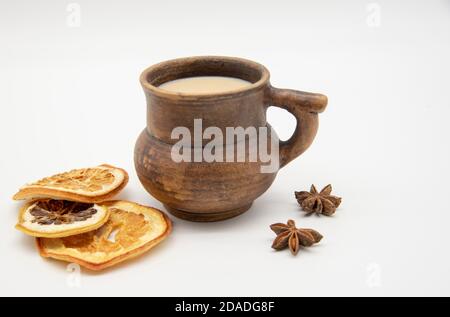 Brown mug and dried oranges on a white background. Stock Photo