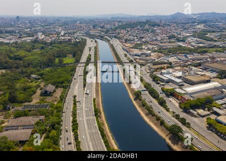 Aerial view of the river between the roads. Stock Photo