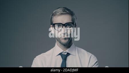 Pensive businessman looking at camera, he is thinking and feeling doubtful Stock Photo