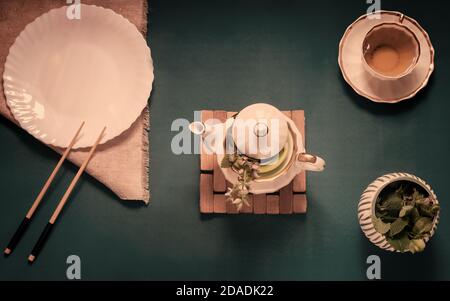 Empty white plate, chopsticks and herbal tea Stock Photo