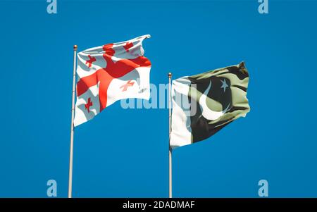 Beautiful national state flags of Georgia and Pakistan together at the sky background. 3D artwork concept. Stock Photo