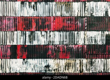 Red and white stripes hand painted on  a rusty fenc. Fragment of stylized image of the American flag Stock Photo