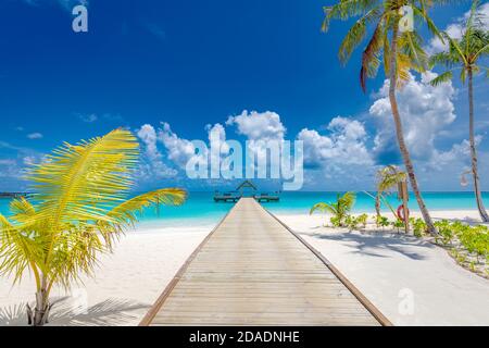 Wooden bridge, jetty at tropical beach in the Maldives at sunny summer day. Amazing summer tropical island beach Stock Photo