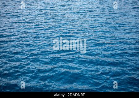 Blue sea water background texture. Blue ocean water with waves background. Soft blue waves - water surface on sea Stock Photo