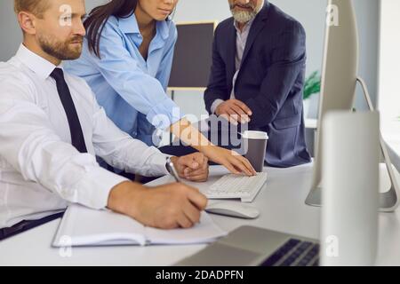 Diverse business people working on important project and using computer for marketing research Stock Photo