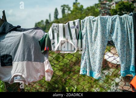 ITAGUI, COLOMBIA - Mar 16, 2019: Itagui, Antioquia / Colombia - March 15 2019: Children's Clothes Hanging and Drying of the Sun over in a Fence Stock Photo
