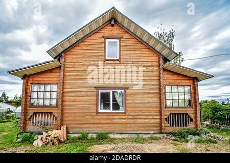 Rustic two-story wooden house, Country life in the summer. Russia Stock Photo