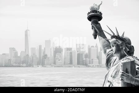 Symbols of New York City. Black and white image ofManhattan skyline in a fog and the statue of Liberty in NYC Stock Photo