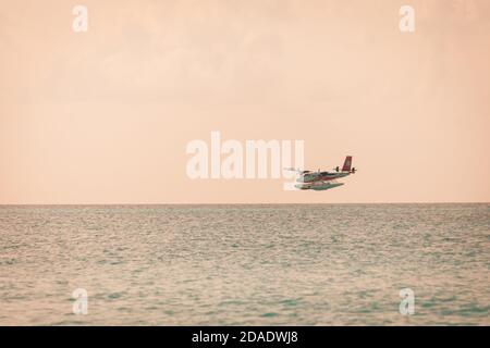 05.06.2019 - Ari Atoll, Maldives: Exotic scene with seaplane on Maldives sea landing. Vacation holiday in Maldives concept background. Seaplane taxi Stock Photo