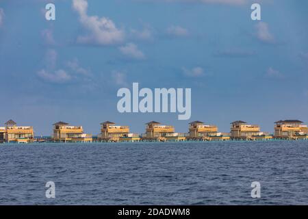 Overwater bungalows at Maldives island. Luxury summer travel vacation destination. Exotic island, sea lagoon, water villas Stock Photo