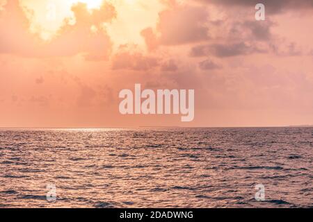 Beautiful sunset over the tropical sea. Beautiful landscape outdoor sea ocean and beach at sunrise or sunset. Idyllic relaxing ecology, endless ocean Stock Photo