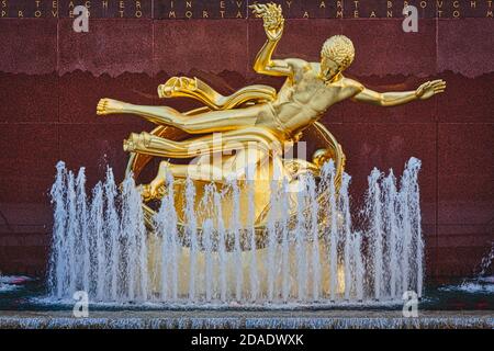 Statue of Prometheus in the lower plaza of the Rockefeller Center, Manhattan, New York, New York State, United States of America. The gilded bronze st Stock Photo