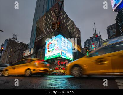 NEW YORK, USA - Apr 30, 2016: Crossroad of 8th Ave and 42nd st. Lights and shadows of NYC. Lights of advertising on streets of Manhattan at evening ti Stock Photo