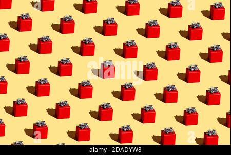 Red gift on a yellow background. Seamless pattern. Wrapping. Stock Photo