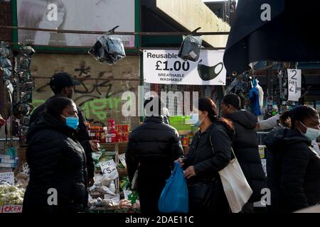 London, Hackney. Ridley Road market during Lockdown 2. Stall selling facemasks. Stock Photo