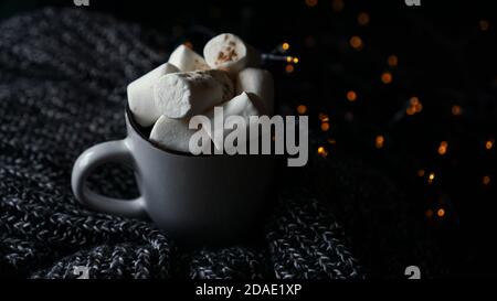 Hot cocoa with marshmallow in a white ceramic mug. The concept of cosy holidays and New Year. Stock Photo