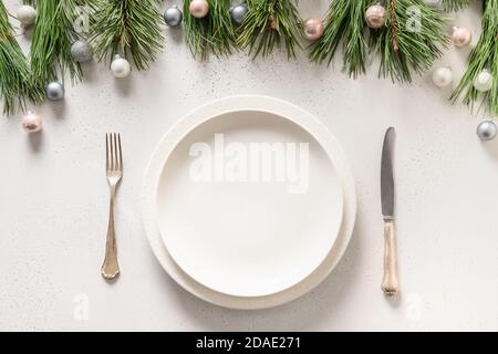 Christmas white table setting with holiday silver decorations. View from above. Stock Photo