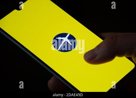 Expedia logo displayed on the smartphone with finger, travel and hotel industry crisis due to Covid or Coronavirus pandemic, data breach Stock Photo