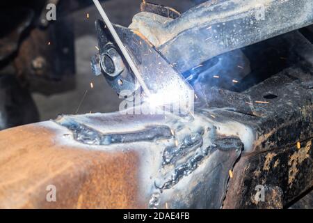 Electrode Arc Welding by Welder at Bottom Car Chassis Area in Zoom View Stock Photo