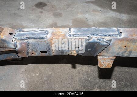 Repairing Car Chassis by Electrode Arc Welding in Car Repair Shop in Wide Angle View Stock Photo