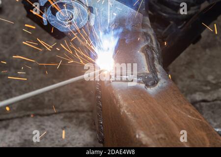 Zoom View Welding Bottom Construction of Car Chassis in Garage by Welder Stock Photo