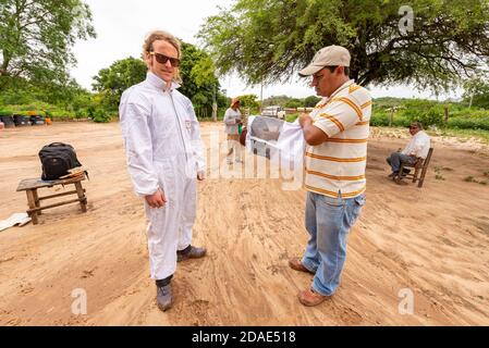 CHARAGUA, BOLIVIA - Jul 30, 2013: Charagua, Santa Cruz / Bolivia - July 29 2013: A White Blond Man with a White Uniform and Black Glasses for the Prot Stock Photo