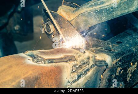 Electrode Arc Welding by Welder at Bottom Car Chassis Area in Zoom View in Vintage Tone Stock Photo