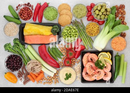 Low glycemic health food for diabetics with vegetables, seafood, dips & pasta with all foods below 55 on the GI index. Stock Photo