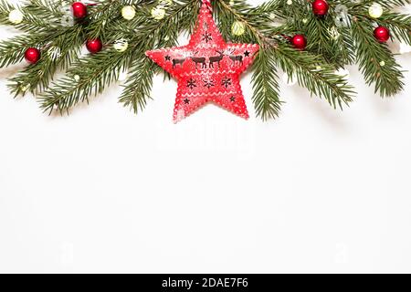 Composition with christmas tree branches, star and christmas lights on white background. Stock Photo