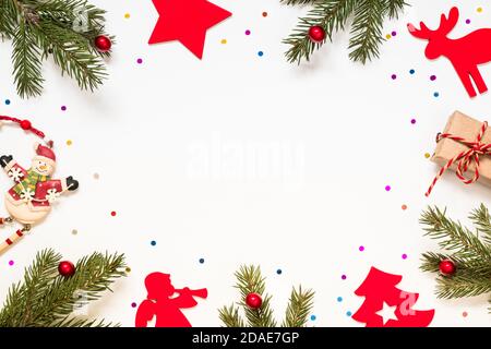 Composition with branches of a christmas tree and christmas decorations on a white background. Stock Photo