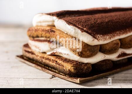 Traditional tiramisu cake on wooden table Stock Photo