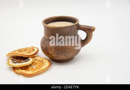 Brown mug and dried oranges on a white background. Stock Photo