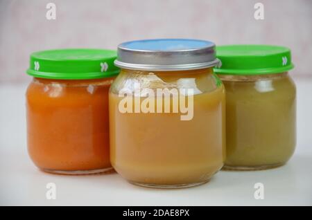 Three jars of baby food on white. Stock Photo