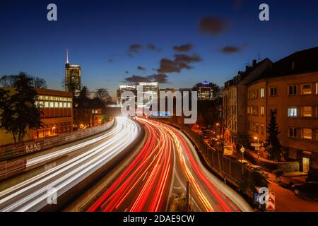 Essen, Ruhr Area, North Rhine-Westphalia, Germany - Motorway A40 at rush hour with view towards Essen city center with the RWE tower, the Evonik head Stock Photo