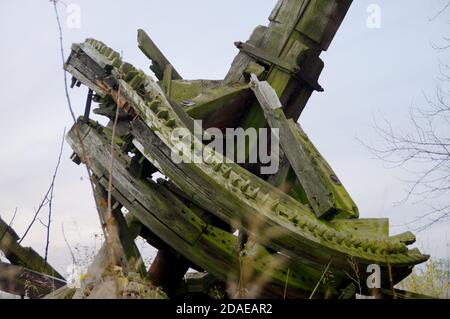 Wooden gear from a damaged windmill. Old forgotten engineering. Stock Photo