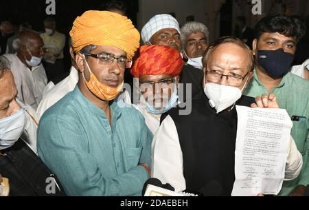 Jaipur, India. 11th Nov, 2020. Gurjar community leader Colonel Kirori Singh Bainsla's son Vijay Bainsla addresses media outside CMR in Jaipur. Energy Minister BD Kalla is also seen. Gurjar agitation, which led to disruption of train services and road blockades in Rajasthan, called off. Gurjars have been agitating over their demands from November 1, 2020. Community demanding that Gehlot government included Gurjar reservation in Ninth Schedule of Constitution. (Photo by Sumit Saraswat/Pacific Press) Credit: Pacific Press Media Production Corp./Alamy Live News Stock Photo