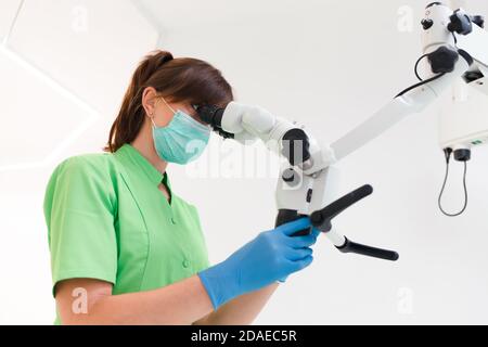 Dentist doctor using dental microscope Stock Photo