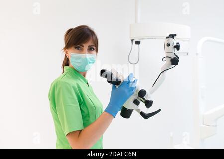 Dentist doctor using dental microscope Stock Photo