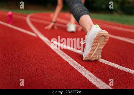 Runner feet in the stadium track Stock Photo