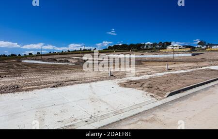 On the outskirts of Melbourne Australia, a new estate is being built, heavy machinery has terraformed the hillside, roads have been laid. Stock Photo