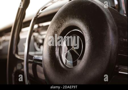 Close up of the steering wheel of a classic Mercedes-Benz car. Stock Photo