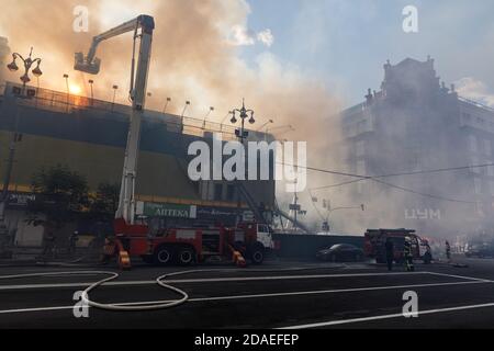 KIEV, UKRAINE - Jun 20, 2017: Ukrainian firefighters try to extinguish a fire in a three-story house on Khreshatyk street, the main street in Kiev. Fi Stock Photo