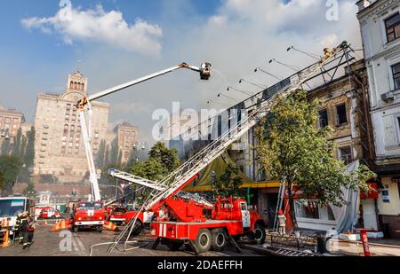 KIEV, UKRAINE - Jun 20, 2017: Ukrainian firefighters try to extinguish a fire in a three-story house on Khreshatyk street, the main street in Kiev. Fi Stock Photo