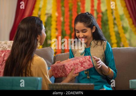 Mother giving her daughter a present Stock Photo